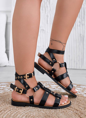 RAMONA - Black flat sandals with straps, studs, and gold buckles