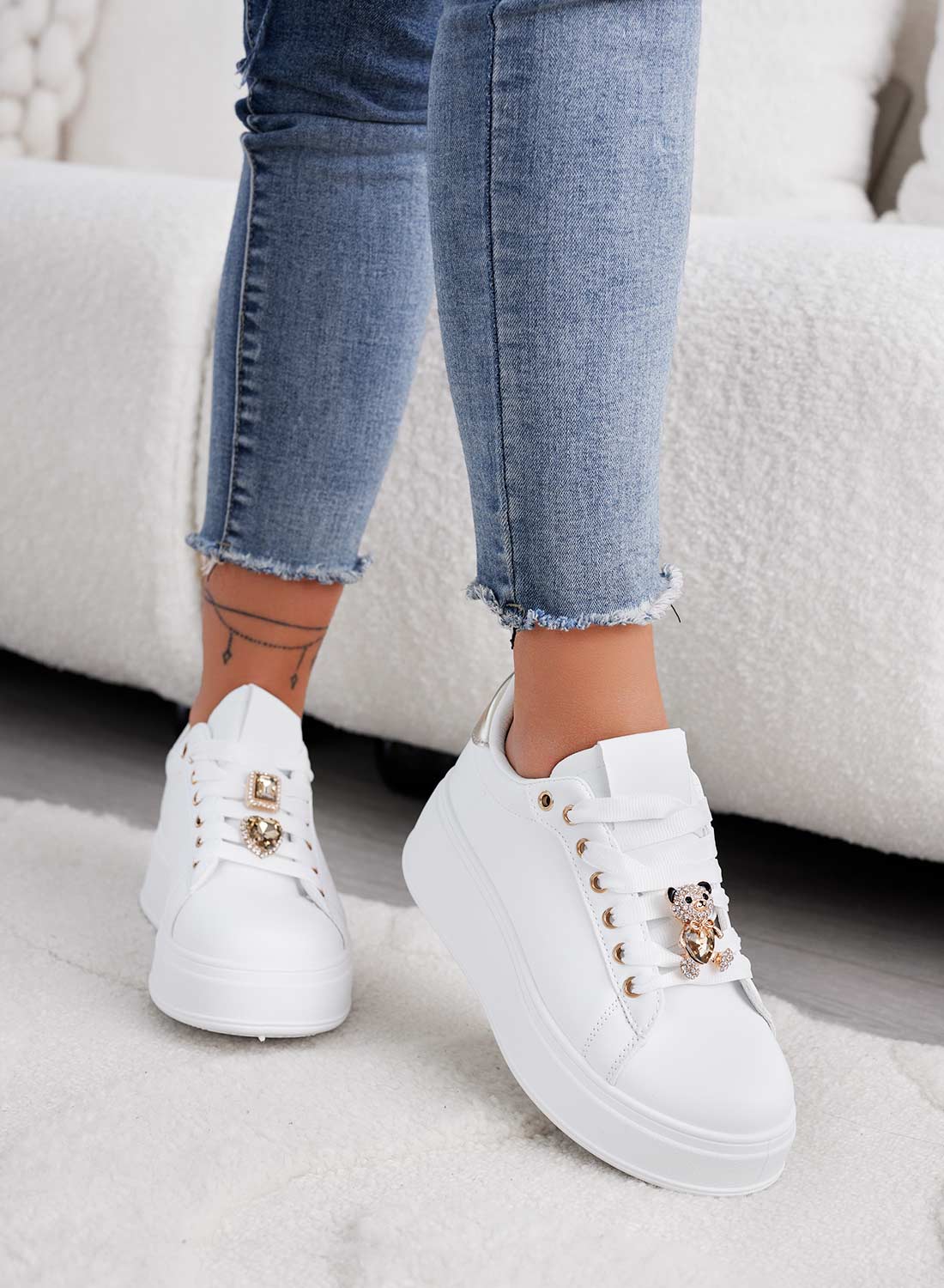 White sneakers with jewel applications and gold teddy
