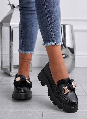 Black loafers with bow and gold teddy brooch