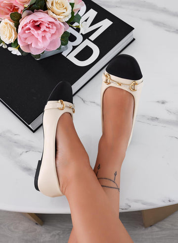 Beige ballet flats with black toe and jewel embellishment