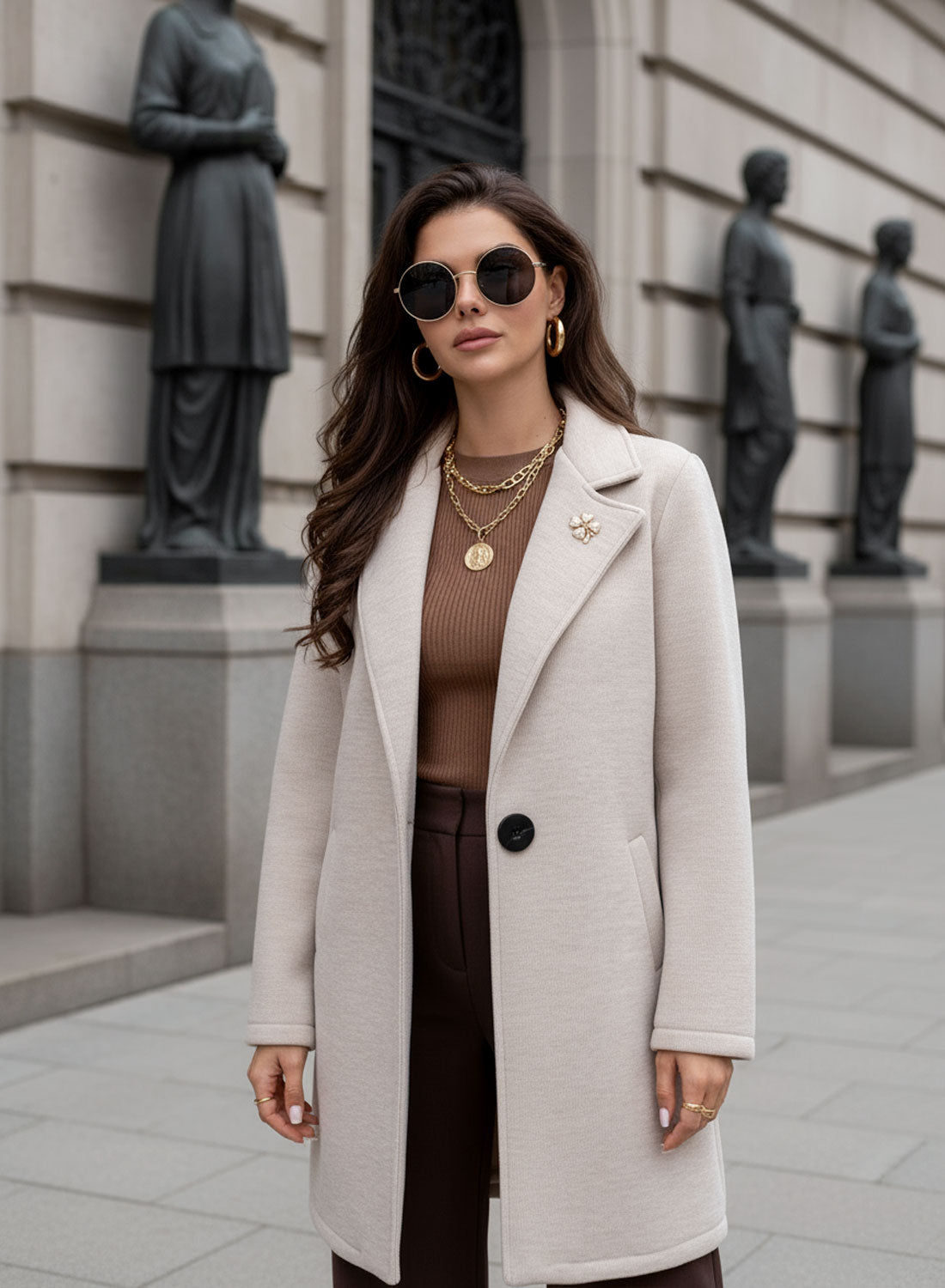 Beige coat with black button and brooch