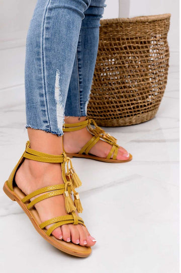 Yellow flat sandals with fringe charms