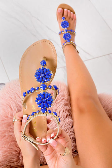 Low gold jeweled thong sandals with blue stones