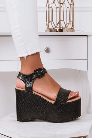 Black python-effect sandals with platform wedge