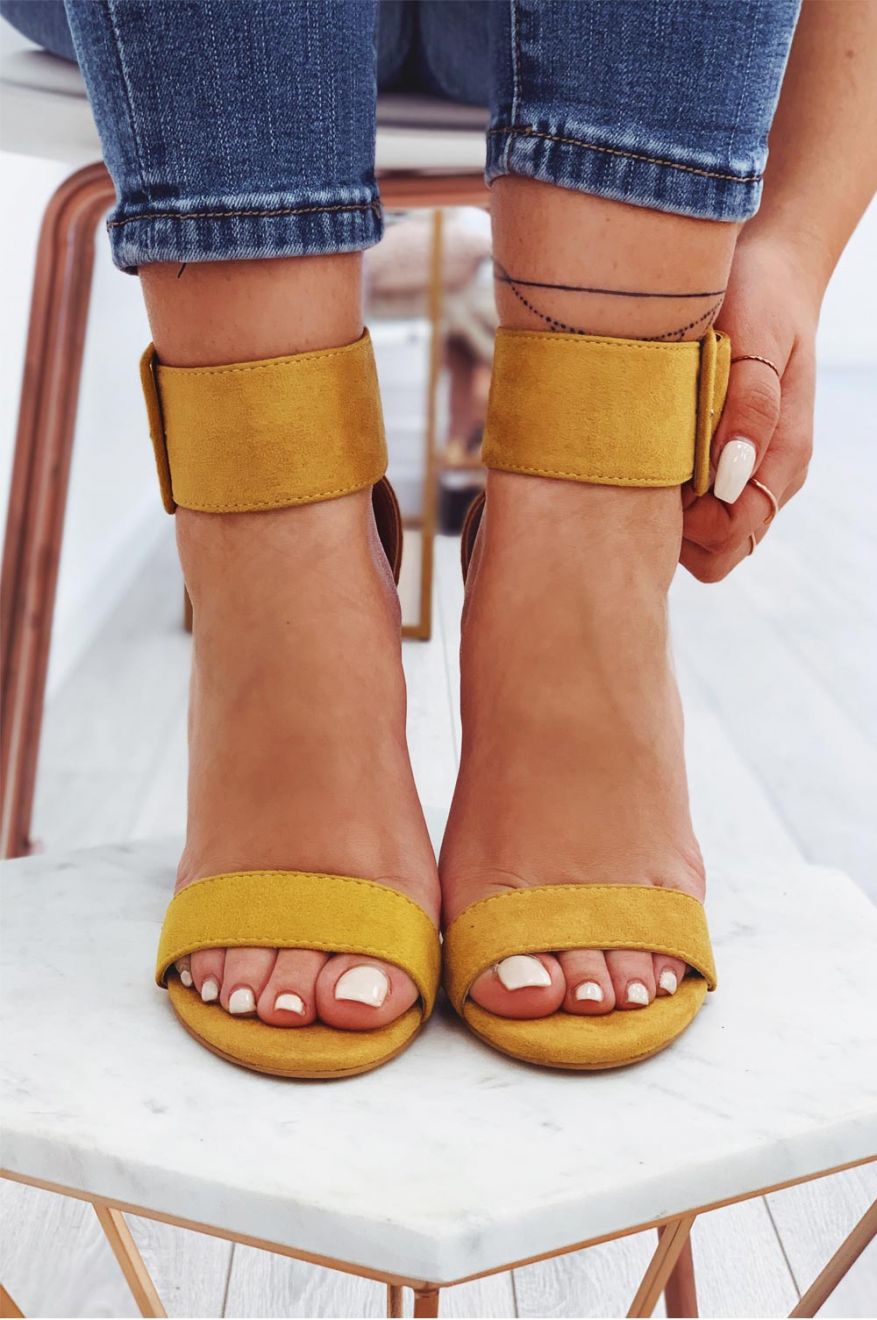 Mustard yellow suede sandals with high heel and ankle strap