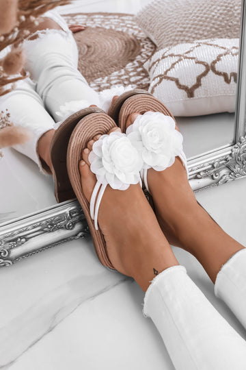White slide sandals with applied flower