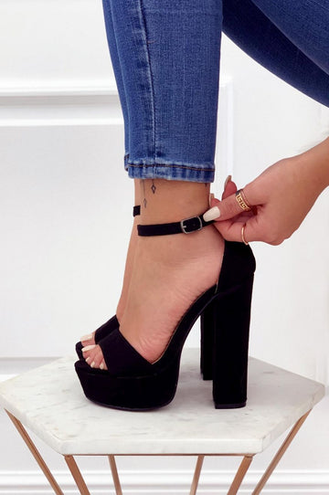 Black suede sandals with high heel and ankle strap
