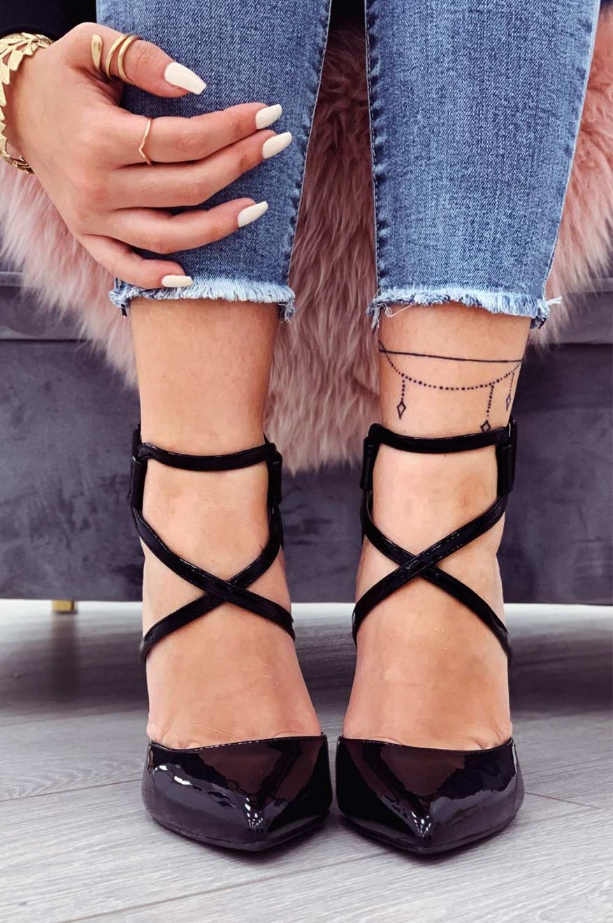 Black patent leather pumps with stiletto heel and buckle