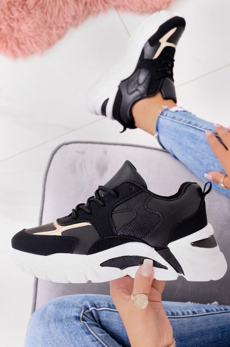 Black sneakers with thick sole and gold inserts