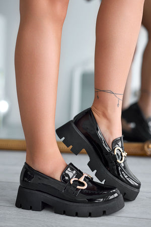 Black patent loafers with gold buckle