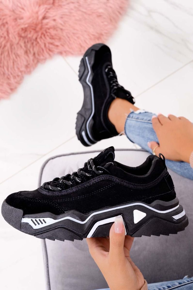 Black suede sneakers with thick sole and laces