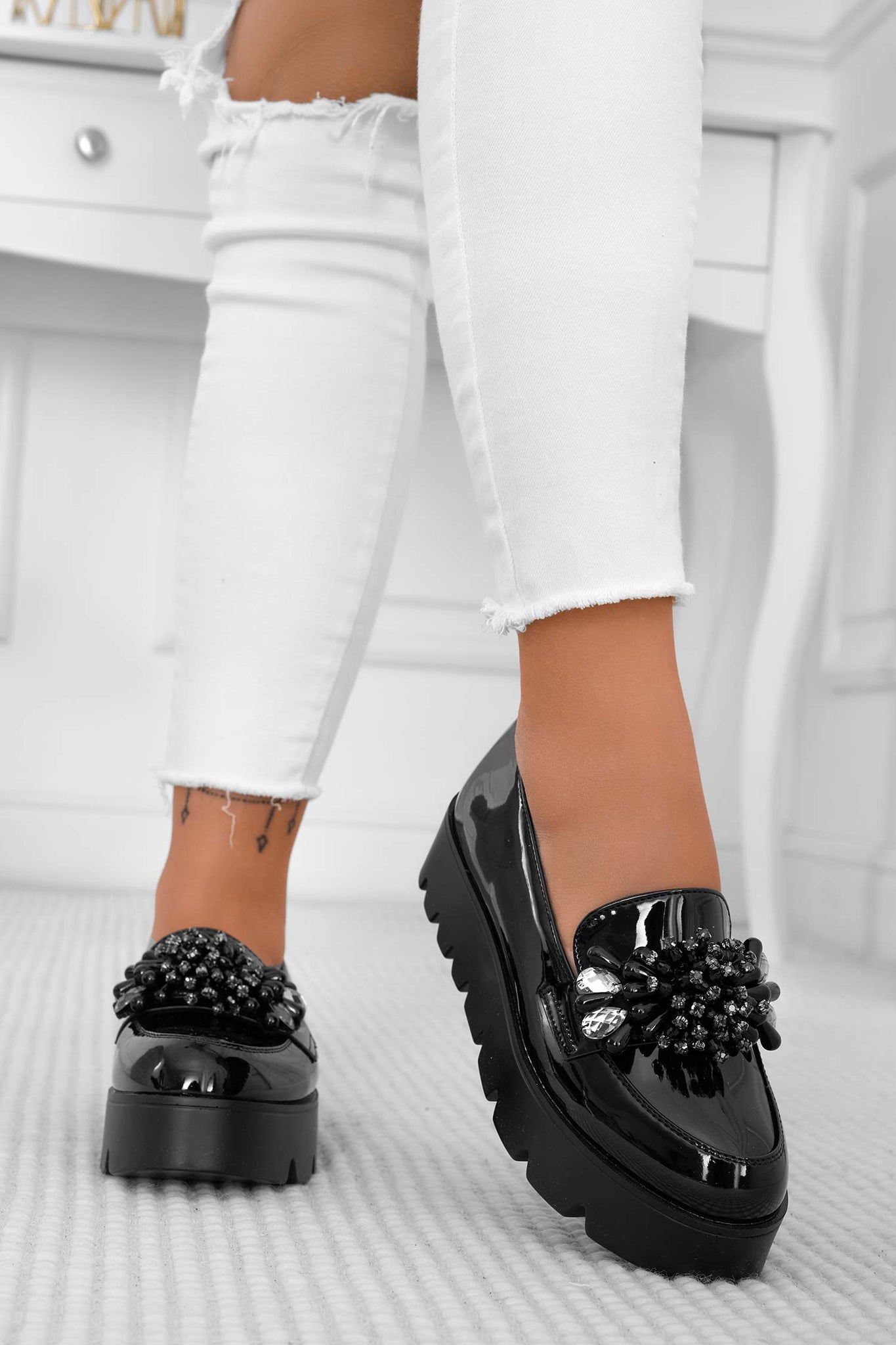 Black patent loafers with jewel embellishment