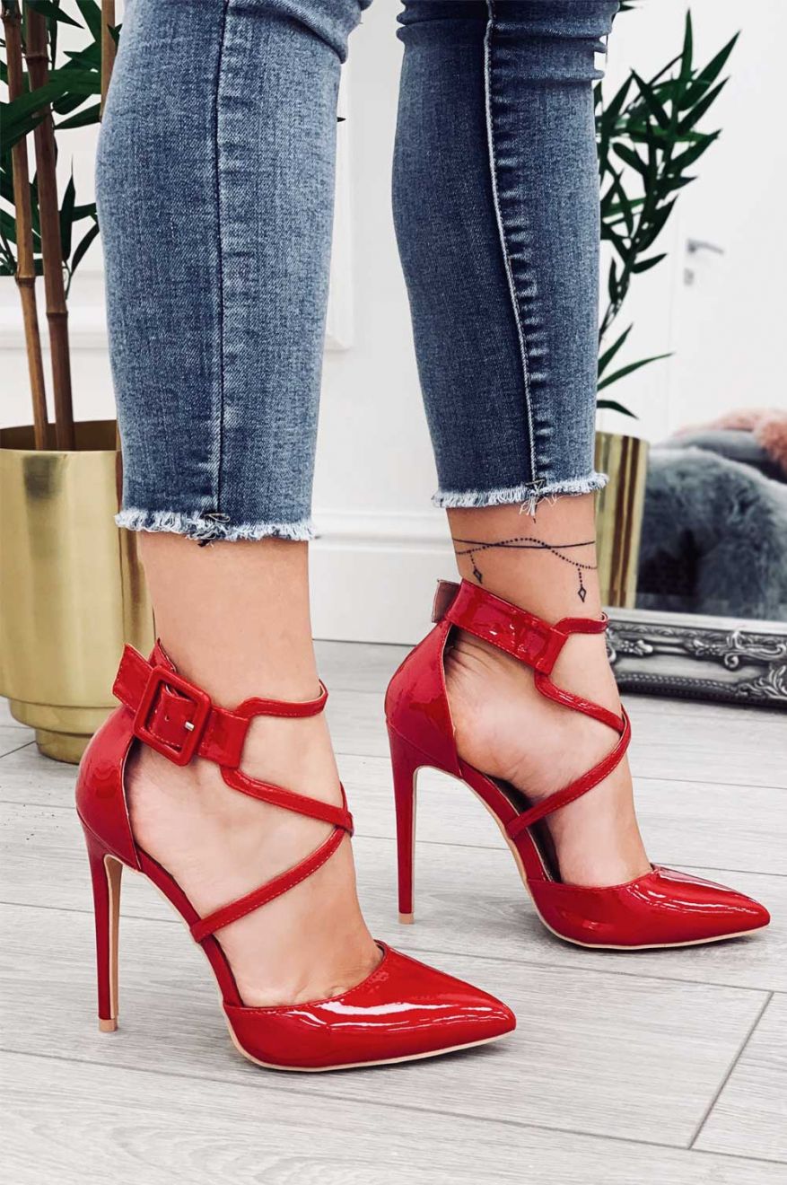 Red patent leather pumps with stiletto heel and buckle