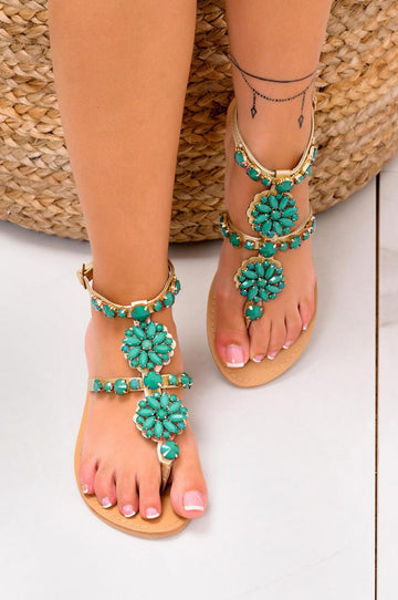 Low gold jeweled thong sandals with green stones
