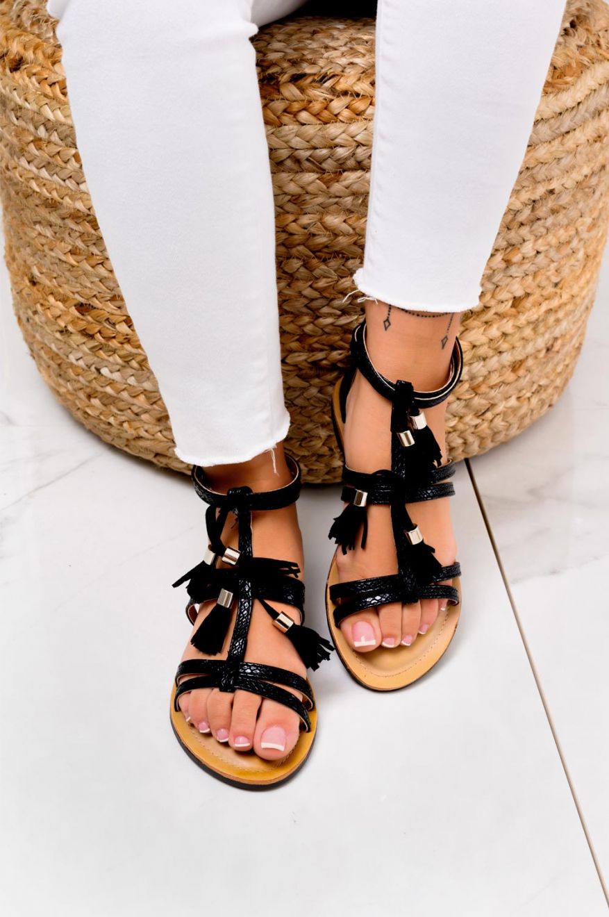 Black flat sandals with fringe charms