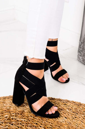 Black sandals with elastic straps and comfortable heel