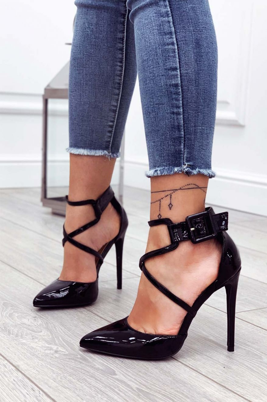 Black patent leather pumps with stiletto heel and buckle