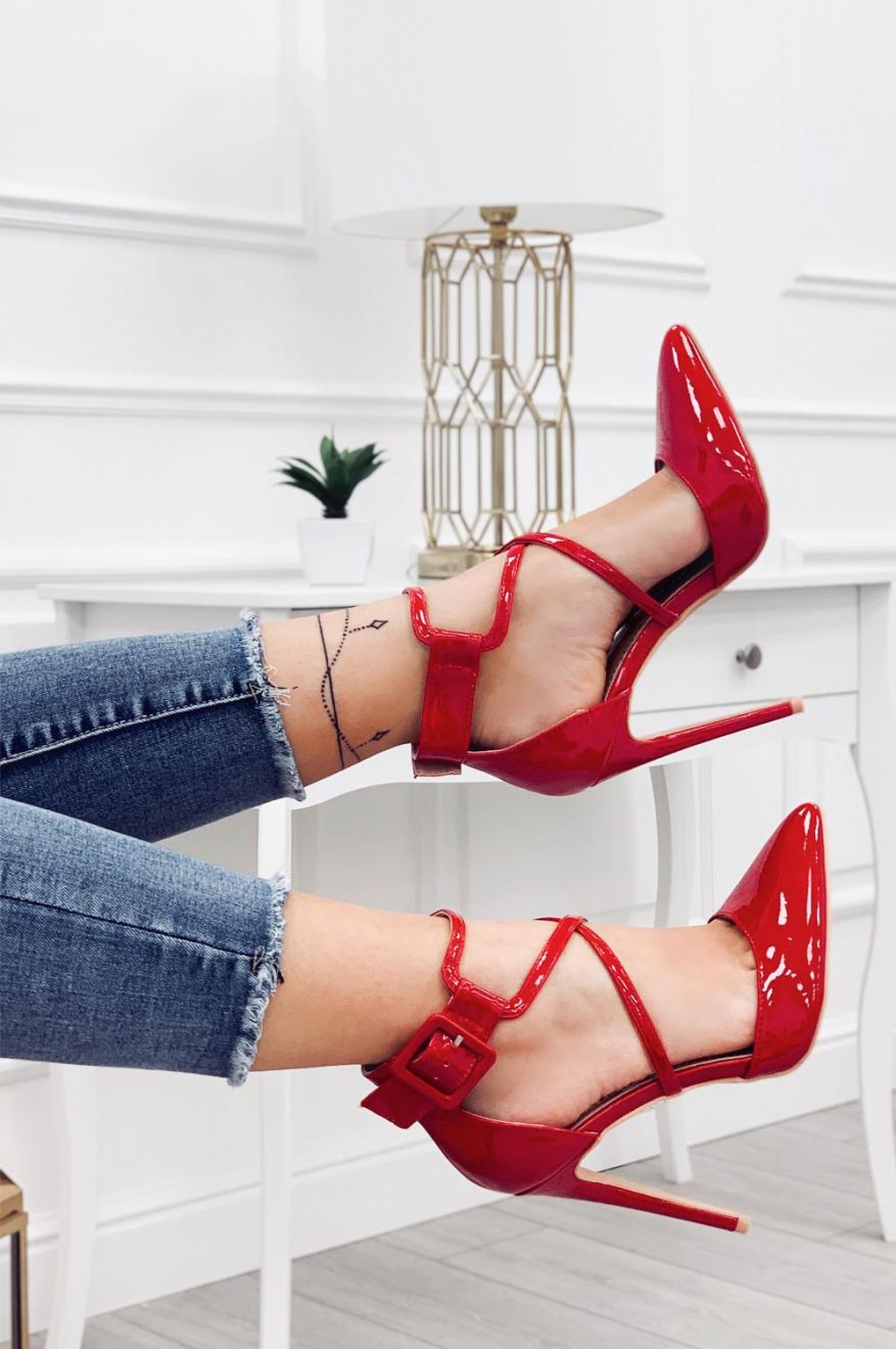 Red patent leather pumps with stiletto heel and buckle