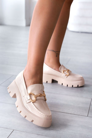 Beige patent loafers with gold buckle