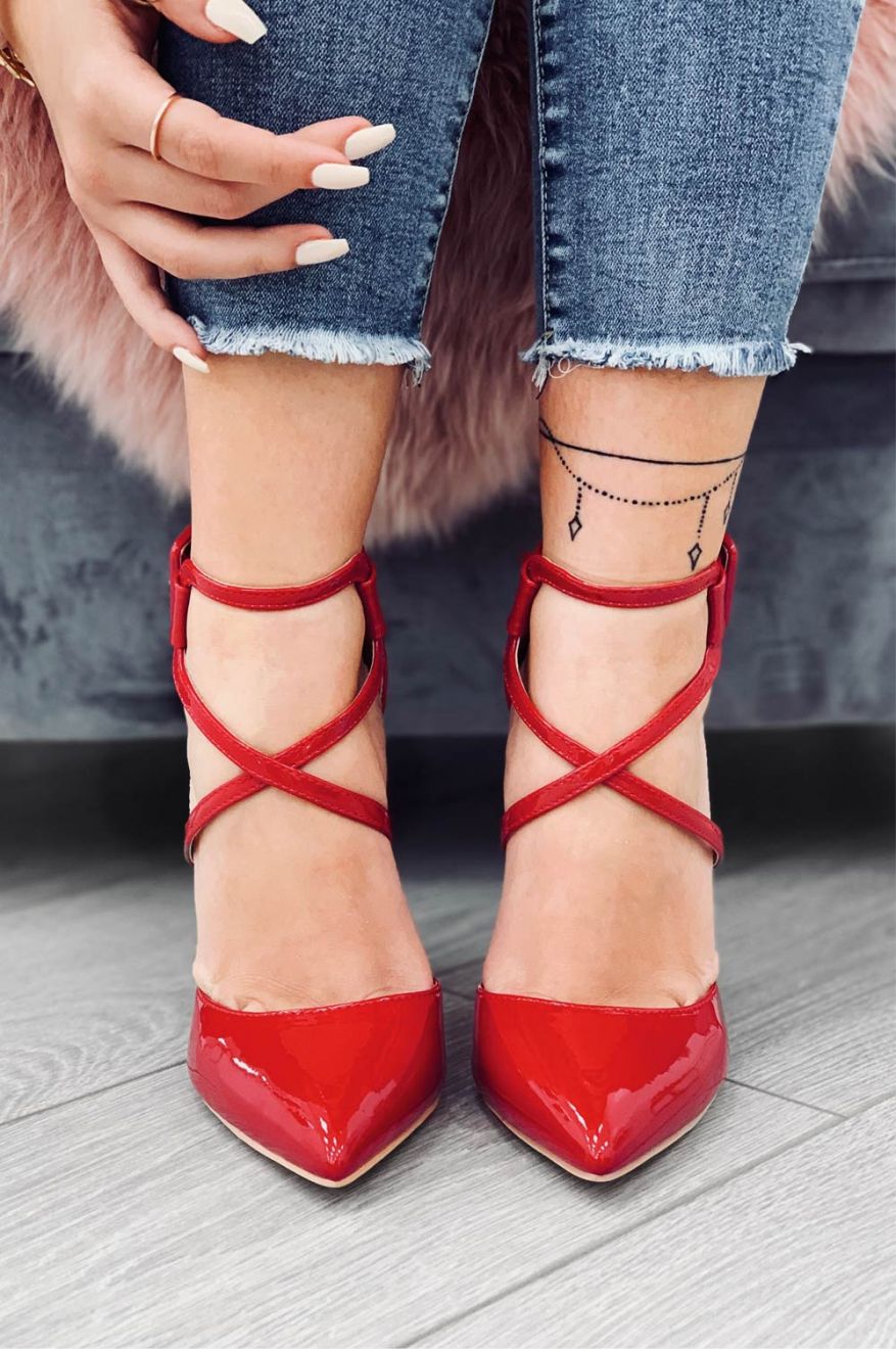 Red patent leather pumps with stiletto heel and buckle