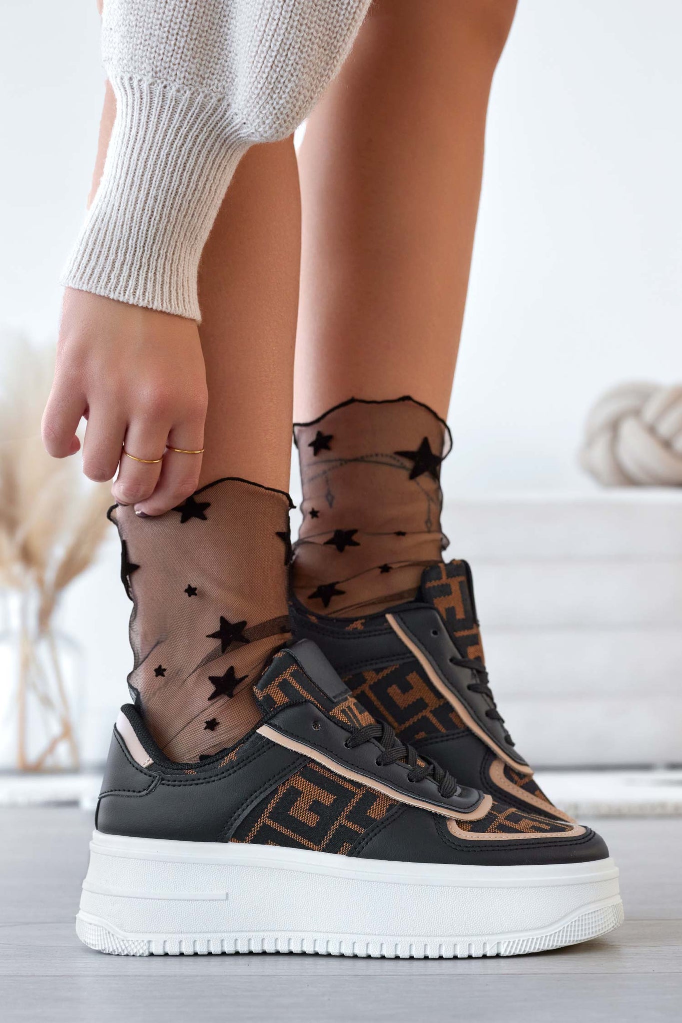 Black sneakers with patterned fabric inserts