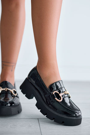 Black patent loafers with gold buckle
