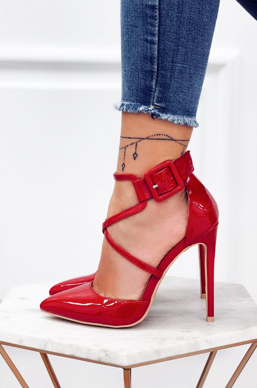 Red patent leather pumps with stiletto heel and buckle