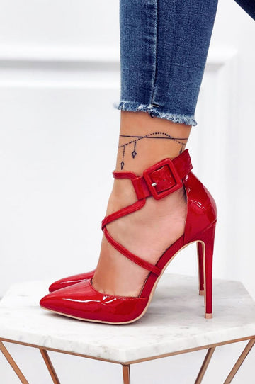 Red patent leather pumps with stiletto heel and buckle